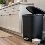 Kitchen trash can with baking soda and trash bags for odor control