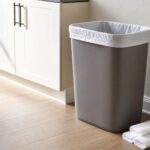 Kitchen trash can with a neatly fitted liner and spare trash bags